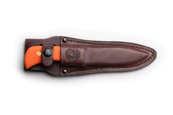 Trekker Whitetail knife with orange Suregrip handle secured in a brown leather sheath.