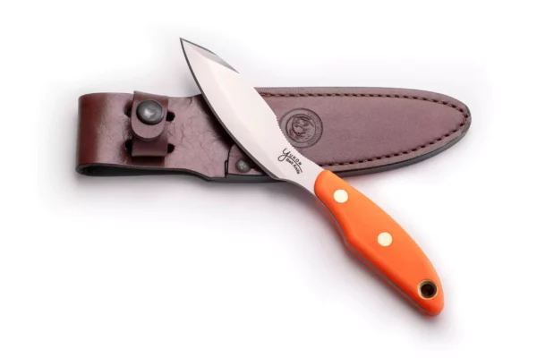 Knives of Alaska Yukon #1 knife with blaze orange SureGrip handle and D2 tool steel blade resting on leather sheath.